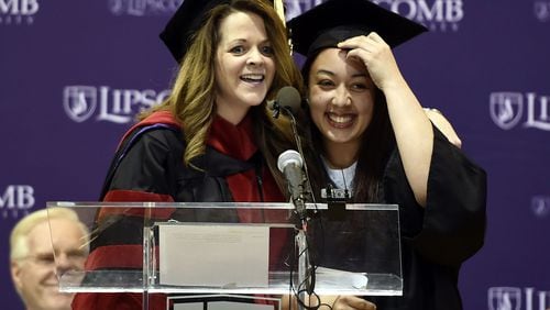 Inmate Cyntoia Brown, right, of the Tennessee Prison for Women gets a hug from a Lipscomb University faculty member after delivering a commencement address in 2015, before she received associate degrees from Lipscomb University in Nashville, Tennessee.