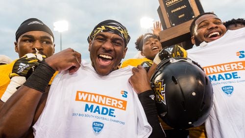 Kennesaw State's Xavier Harper (middle) holds up the Big South Champions t-shirt after the Owls' victory, Saturday, Nov. 18, 2017. (Special by Cory Hancock)