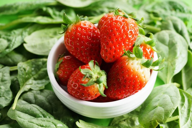 Strawberries and spinach (stock photo)