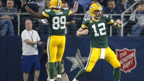 Green Bay Packers quarterback Aaron Rodgers and tight end Jared Cook celebrate after a touchdown during the first half of an NFC divisional playoff football game against the Dallas Cowboys Sunday in Arlington, Texas. (AP photo)