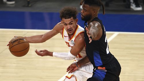 Atlanta Hawks' Trae Young, left, tries to get past New York Knicks' Reggie Bullock during the fourth quarter in Game 2 in an NBA basketball first-round playoff series Wednesday, May 26, 2021, in New York. (Elsa/Pool Photo via AP)