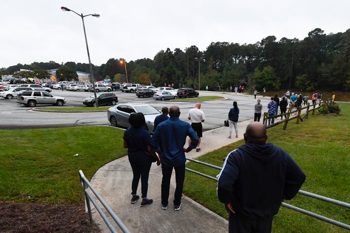 A line to vote snakes around the parking lot as the first day of early voting gets underway on Monday, Oct. 12, 2020, at the Mountain Park Activity Building in Stone Mountain. JOHN AMIS FOR THE ATLANTA JOURNAL- CONSTITUTION