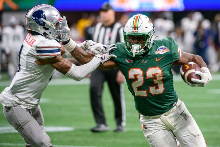 Florida A&M running back Terrell Jennings gets past Howard defensive back Lance McMillian during the Celebration Bowl at Mercedes Benz Stadium in Atlanta, Georgia on Dec. 16, 2023. (Jamie Spaar for the Atlanta Journal Constitution)