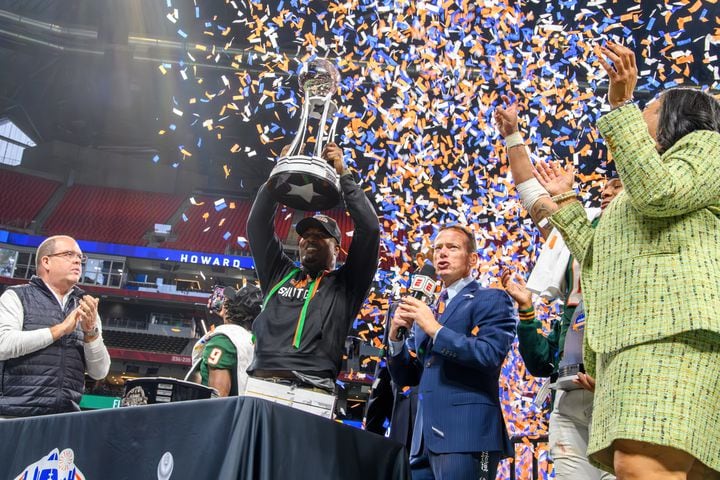 Florida A&M head coach Willie Simmons receives the trophy for winning the Celebration Bowl against Howard at Mercedes Benz Stadium in A tlanta, Georgia on Dec. 16, 2023. (Jamie Spaar for the Atlanta Journal Constitution)