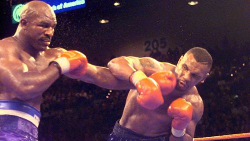 Evander Holyfield unloads on Mike Tyson during the 11th round of their first fight in 1996.