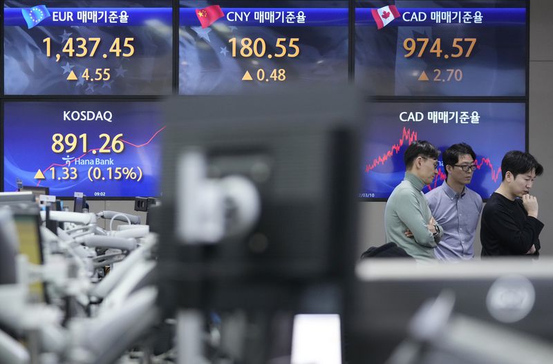 Currency traders work at the foreign exchange dealing room of the KEB Hana Bank headquarters in Seoul, South Korea, Thursday, March 14, 2024. Asian shares mostly declined Thursday in lackluster trading after U.S. stocks drifted to a mixed finish.(AP Photo/Ahn Young-joon)