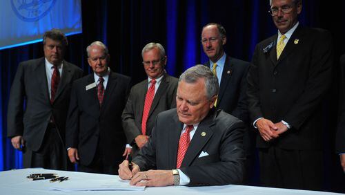 April 19, 2012: College Park, GA: Gov. Nathan Deal signs a bill that will overhaul the state's tax code Thursday April 19, 2012. The signing took place during the Governor's Award Luncheon, part of Georgia's Manufacturing Appreciation Week. Brant Sanderlin bsanderlin@ajc.com