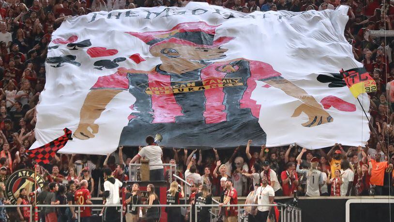 Atlanta United fans hoist a tifo of Josef Martinez, who tied the MLS season scoring record with his 27th goal in Sunday’s win. Curtis Compton/ccompton@ajc.com