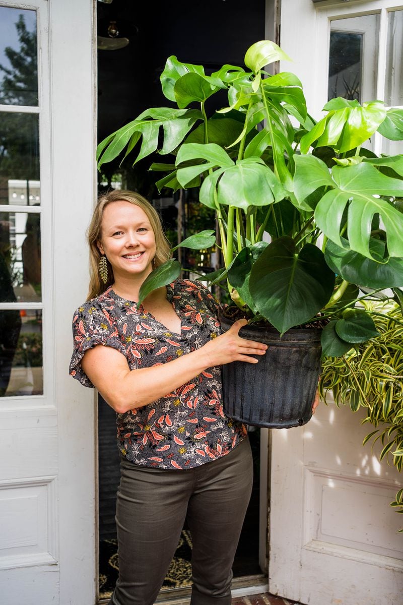 Andrea Kidd holds a monstera deliciosa outside of Lush Plant Co.’s opening night of its Decatur store in 2021. 
Courtesy of Lush Plant Co.