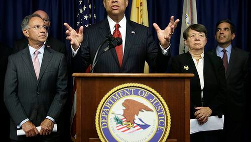 United States Secretary of Homeland Security Jeh Johnson, center, speaks during a news conference in Newark, N.J., Tuesday, Aug. 11, 2015. An international group of hackers and stock traders made $30 million by breaking into the computers of newswire services that put out corporate press releases and trading on the information before it was made public, federal prosecutors said Tuesday. (AP Photo/Seth Wenig)
