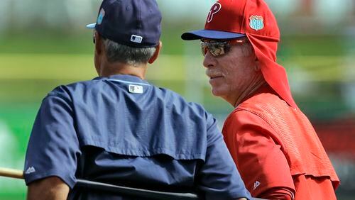 FILE - In this March 17, 2016, file photo, Philadelphia Phillies instructor Mike Schmidt, right, talks to Tampa Bay Rays bench coach Tom Foley before a spring training baseball game in Clearwater, Fla. "The players used to settle issues themselves. Cross the line and someone had to pay, nearly always the players got it right and settled it themselves. Umpires are now the baseball police, which has made the game safer but also softer, " says Schmidt (AP Photo/Chris O'Meara, File)