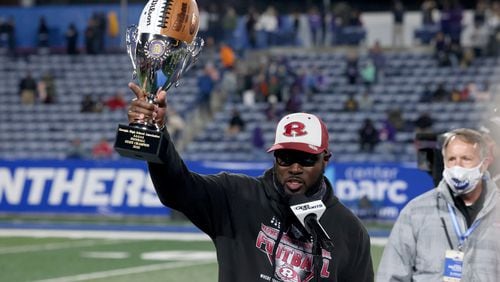 Dec. 30, 2020 - Atlanta, Ga: Warner Robins coach Marquis Westbrook celebrates with the trophy after their 62-28 win against against Cartersville in the Class 5A state high school football final at Center Parc Stadium Wednesday, December 30, 2020 in Atlanta. JASON GETZ FOR THE ATLANTA JOURNAL-CONSTITUTION






