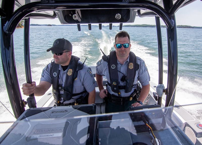 Game Warden Corporal Dan Schay (left) and Kevin Goss head out on a safety patrol on Lake Lanier on May 21, 2021.  STEVE SCHAEFER FOR THE ATLANTA JOURNAL-CONSTITUTION
