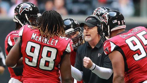 Falcons head coach Dan Quinn talks with his defense during a first half time out against the Tampa Bay Buccaneers Sunday, Oct 14, 2018, in Atlanta.  The Falcons scored their second win of the season.