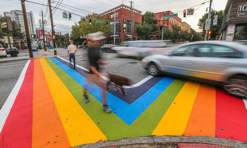Motorists and pedestrians had a brand new perspective of 10th and Piedmont Avenue in 2015. There was a project to paint rainbow crosswalks in Midtown for the launch of Atlanta Pride. JOHN SPINK /JSPINK@AJC.COM