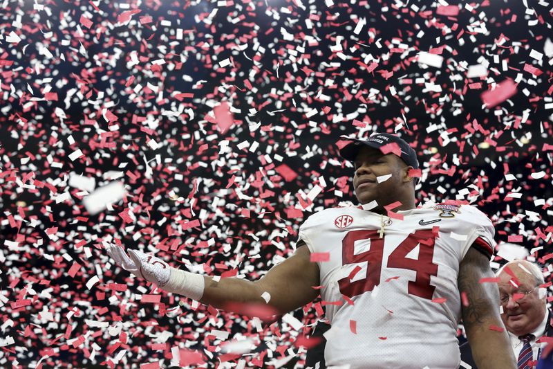 The defensive star of the Sugar Bowl, Alabama defensive lineman Da'Ron Payne, bathes in the confetti of victory late Monday night in New Orleans. (AP Photo/Rusty Costanza)