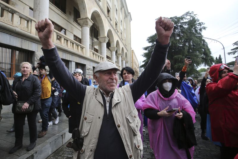 Demonstrators react as police leave an area around the Parliament building during an opposition protest against "the Russian law" in the center of Tbilisi, Georgia, on Monday, May 13, 2024. Daily protests are continuing against a proposed bill that critics say would stifle media freedom and obstruct the country's bid to join the European Union. (AP Photo/Zurab Tsertsvadze)