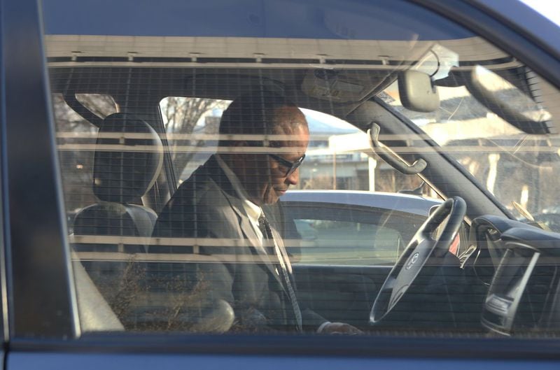 Atlanta contractor Elvin “E.R.” Mitchell Jr. returns to his car after pleading guilty to conspiracy during a January hearing at the federal courthouse in Atlanta. (HENRY TAYLOR / HENRY.TAYLOR@AJC.COM)