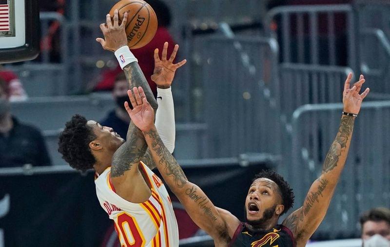 Cleveland Cavaliers' Lamar Stevens (8) and Atlanta Hawks' John Collins (20) battle for a loose ball in the first half Tuesday, Feb. 23, 2021, in Cleveland. Stevens was called for the foul. (Tony Dejak/AP)