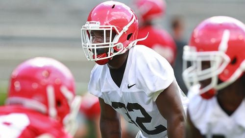 Georgia linebacker Monty Rice (center) works against the offense on a play during team practice at Fan Day on Saturday, Aug. 4, 2018, in Athens.