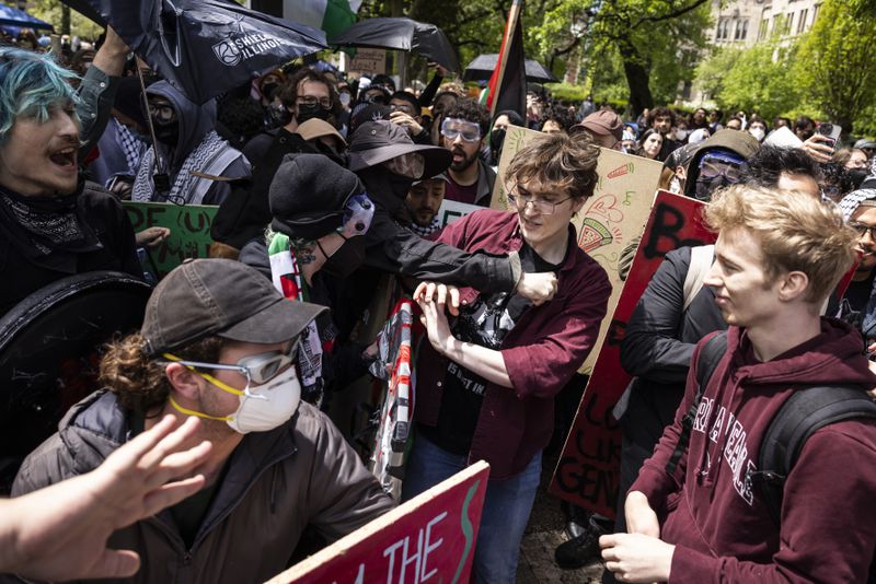 Pro-Palestinians protesters clash with counter-protesters at the encampment in the quad at the University of Chicago on the South Side, Friday, May 3, 2024. (Ashlee Rezin/Chicago Sun-Times via AP)