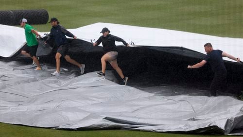 Groundcrew put the tarp on the infield before game three between Cartersville and Loganville in the Class 5A GHSA baseball finals at Coolray Field, Friday, May 17, 2024, in Lawrenceville, Ga. (Jason Getz / AJC)
