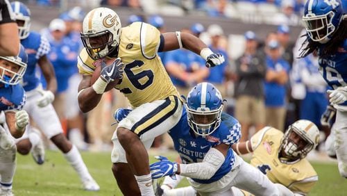Georgia Tech running back Dedrick Mills (26) is tackled by Kentucky safety Mike Edwards (27) during the TaxSlayer Bowl in Jacksonville, Fla., on Dec. 31, 2016.