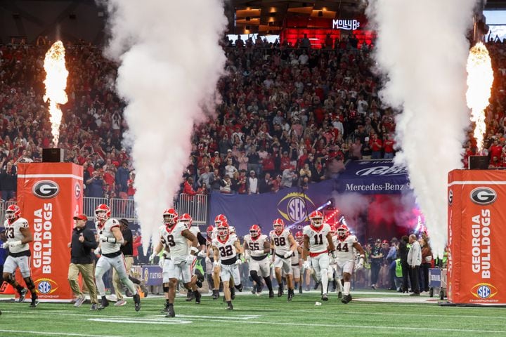 The Georgia Bulldogs enter the field to face the Alabama Crimson Tide during the first half of the SEC Championship football game at the Mercedes-Benz Stadium in Atlanta, on Saturday, December 2, 2023. (Jason Getz / Jason.Getz@ajc.com)