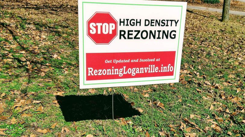 Handed out by concerned residents, signs are scattered around Southeastern Gwinnett County to raise awareness of a proposed development that would add high-density homes near Loganville Highway. (Courtesy of Shannon Rowland)