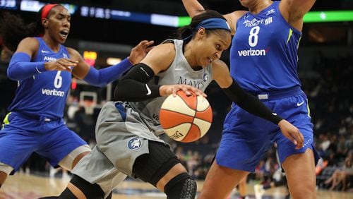 The Minnesota Lynx's Maya Moore dribbles past the Dallas Wings' Kayla Thornton, left, and Liz Cambage at Target Center in Minneapolis on Tuesday, June 19, 2018. The Lynx won, 91-83. (Jerry Holt/Minneapolis Star Tribune/TNS)