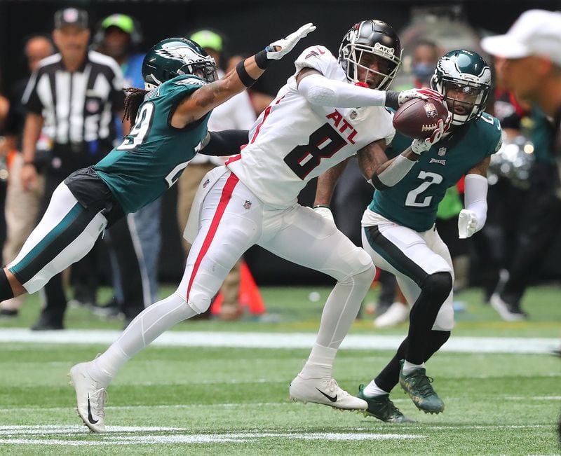 Falcons rookie tight end Kyle Pitts makes a reception against a double team by Philadelphia Eagles defenders during the fourth quarter Sunday, Sept. 12, 2021, at Mercedes-Benz Stadium in Atlanta. (Curtis Compton / Curtis.Compton@ajc.com)