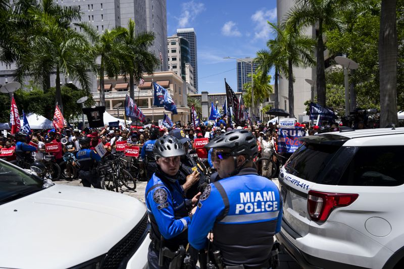 Miami Police watch over supporters of former President Donald Trump outside the Wilkie D. Ferguson Jr. U.S. Courthouse while Trump was making his first court appearance inside in Miami, June 13, 2023. (Doug Mills/The New York Times)