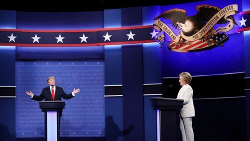 Republican presidential nominee Donald Trump speaks as Democrat Hillary Clinton looks on during the third presidential debate in Las Vegas. Win McNamee/Getty Images