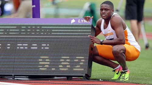 Christian Coleman poses next to his record-time scoreboard during the NCAA track and field championships at Hayward Field in Eugene, Oregon. Photo By Donald Page/Tennessee Athletics