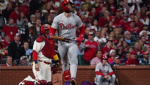 Philadelphia Phillies' Bryce Harper watches his solo home run against the St. Louis Cardinals during the second inning in Game 2 of an NL wild-card baseball playoff series Saturday, Oct. 8, 2022, in St. Louis. (AP Photo/Jeff Roberson)