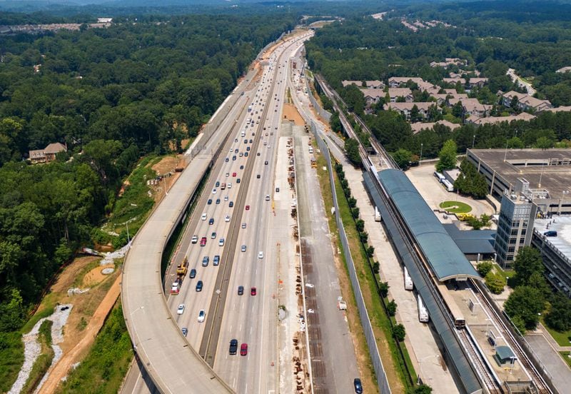 July 22, 2021 Sandy Springs - Aerial photo shows Ga. 400 (R-Northbound, L-Southbound), where toll lanes will be built on Thursday, July 22, 2021. North Springs MARTA station is shown on right. Sixteen miles of toll lanes stretching from the North Springs MARTA station to about one mile north of McFarland Parkway in Fulton and Forsyth counties. (Hyosub Shin / Hyosub.Shin@ajc.com)