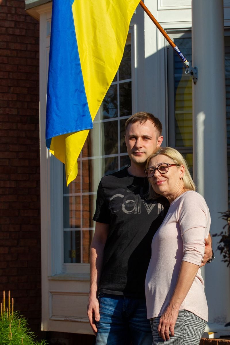 Igor Lutsenko poses for a photograph outside his Lawrenceville home with his mother, Lyudmila Soloshenko Friday, March 4, 2022.  STEVE SCHAEFER FOR THE ATLANTA JOURNAL-CONSTITUTION