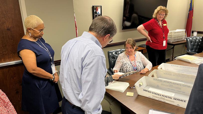 Cityhood supporter Jimmy Eastham (center) and Cobb Elections Director Janine Eveler (right) look on as election workers conduct a partial recount of the Vinings cityhood election Monday, June 6, 2022 in Marietta.