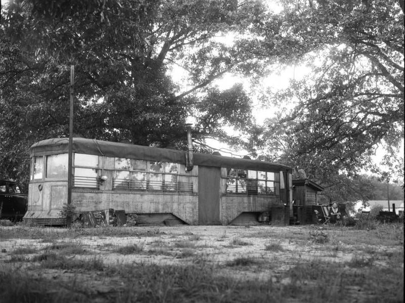 Frances E. Zahn sits outside her repurposed streetcar home in Avondale Estates, sometime after 1937. (AJC Archive at the GSU Library AJCN083-027a)