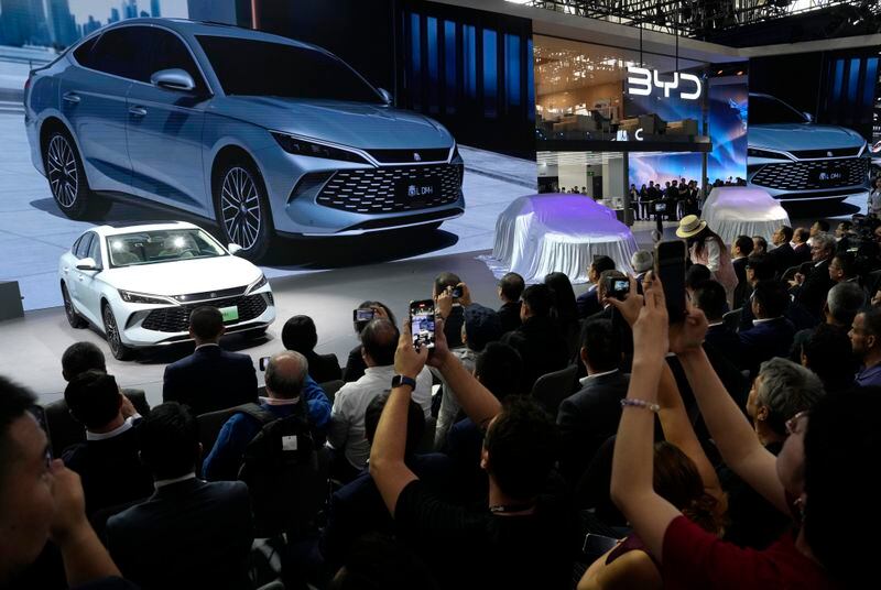 Attendees take photos of the BYD Qin L Dmi unveiled during Auto China 2024 held in Beijing, Thursday, April 25, 2024. (AP Photo/Ng Han Guan)