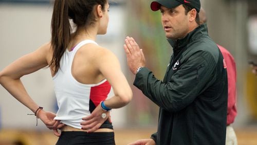 Georgia’s Petros Kyprianou instructs high jumper Leontia Kallenou during a meet in 2015. Kyprianou (KIP-ree-AH-noo) has led the Bulldogs to two national championships in his seen seasons. (Photo by Elliott Hess/UGA Athletics)