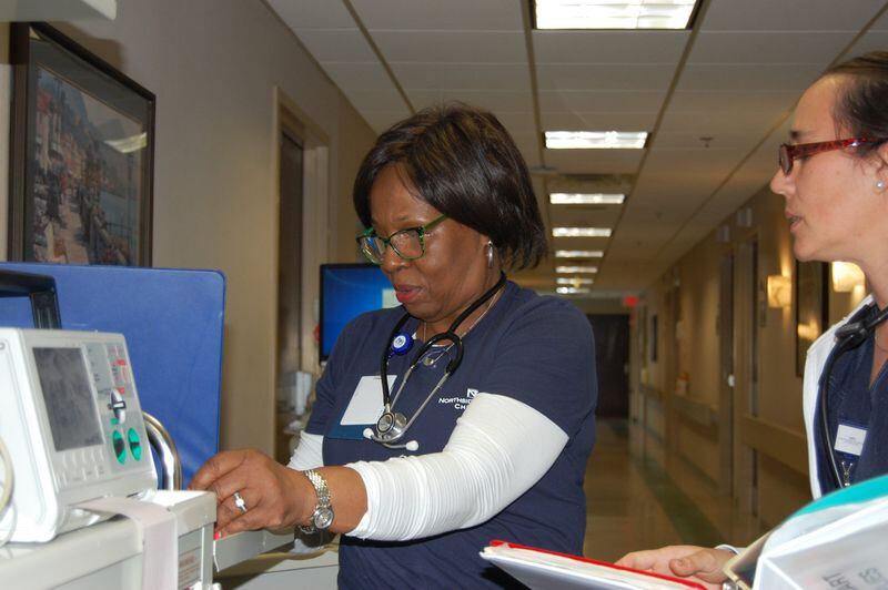 Velma Blackwell, a nurse at Northside Hospital Cherokee, reviews patient charts with a care team member during her shift. CONTRIBUTED