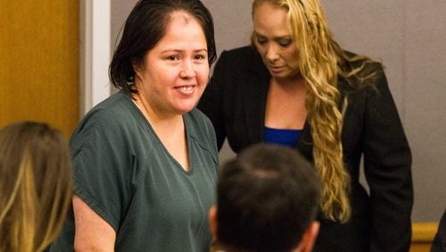 Isabel Martinez, center, enters the courtroom during her arraignment at the Gwinnett Justice and Administration Center in Lawrenceville, Georgia, on Monday, April 16, 2018. Martinez is pleading not guilty to killing her husband and four of her children in July 2017.