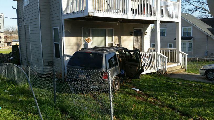 A Ford Explorer hit a house on North Avenue after the driver was shot twice in the back. (Credit: Atlanta Police Department)