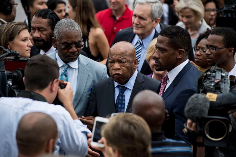 UNITED STATES - JUNE 23: Rep. John Lewis, D-Ga., right, and Rep. Gregory Meeks, D-N.Y., left, wade through the crowd of demonstrators on the East Plaza of the Capitol supporting the Democrats' sit-in for gun control legislation on Thursday, June 23, 2016. Rep. Lewis brought the sit-in to an end at 1 p.m., Thursday, thanking members for the 25-hour siege. (Photo By Bill Clark/CQ Roll Call)
 (CQ Roll Call via AP Images)