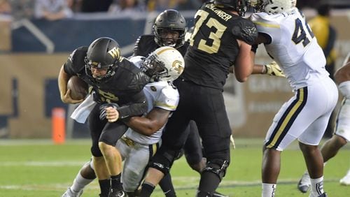 October 21, 2017 Atlanta - Wake Forest quarterback John Wolford (10) is taken down by Georgia Tech linebacker Victor Alexander (9) in the second half of an NCAA college football game at Bobby Dodd Stadium on Saturday, October 21, 2017. Georgia Tech beat Wake Forest 38-24. HYOSUB SHIN / HSHIN@AJC.COM