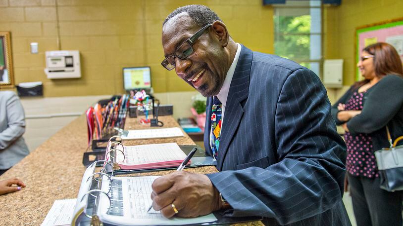 Steven Green, the new superintendent for Dekalb County schools, signs the visitors log before touring a DeKalb elementary school in this AJC file photo.