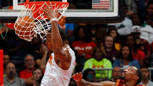 Dwight Howard of the Hawks dunks past Jordan McRae of the Cavaliers at Philips Arena on October 10, 2016 in Atlanta, Georgia. (Photo by Kevin C. Cox/Getty Images)