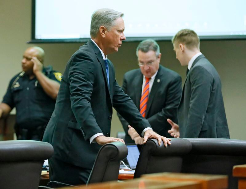 October 2, 2019 - Decatur -  Former DeKalb County Police Officer Robert "Chip" Olsen (center) stands during a morning break. The murder trial of former DeKalb County Police Officer Robert "Chip" Olsen continued today.  Olsen is charged with murdering war veteran Anthony Hill.  Bob Andres / robert.andres@ajc.com