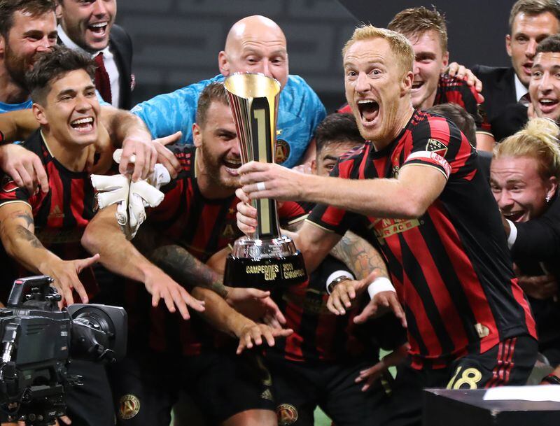 Atlanta United captain Jeff Larentowicz hoists the trophy for the team to celebrate a 3-2 victory over Club America to win the Campeones Cup on Wednesday, August 14, 2019, in Atlanta.   Curtis Compton/ccompton@ajc.com